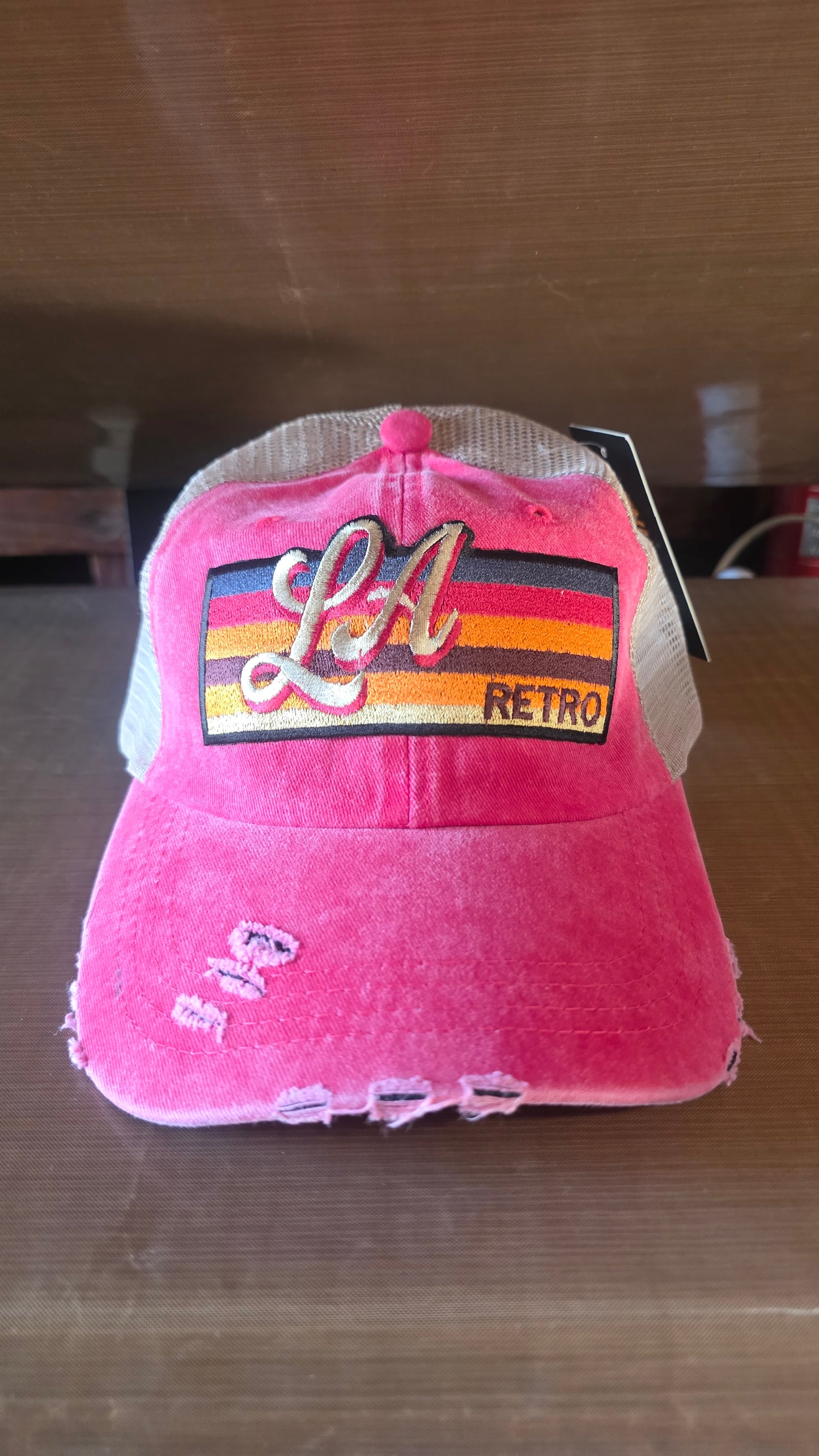 Distressed pink denim and tan mesh trucker hat
